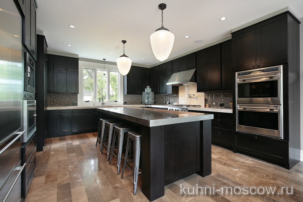 Kitchen in luxury home with dark wood cabinetry